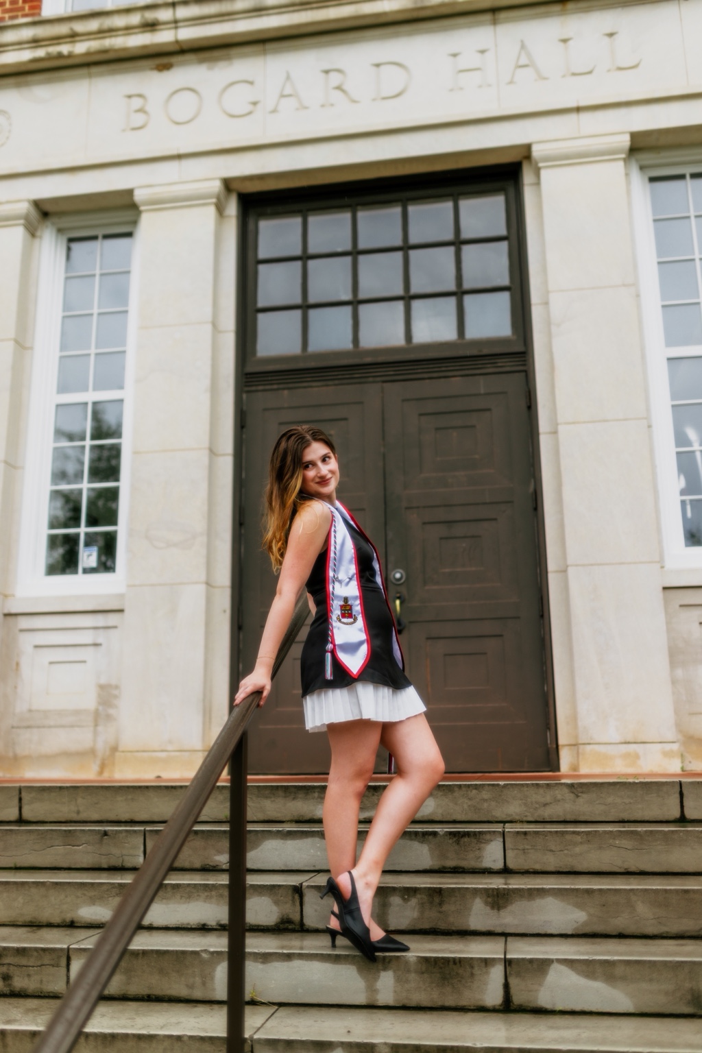 Graduate on the steps of Bogard Hall