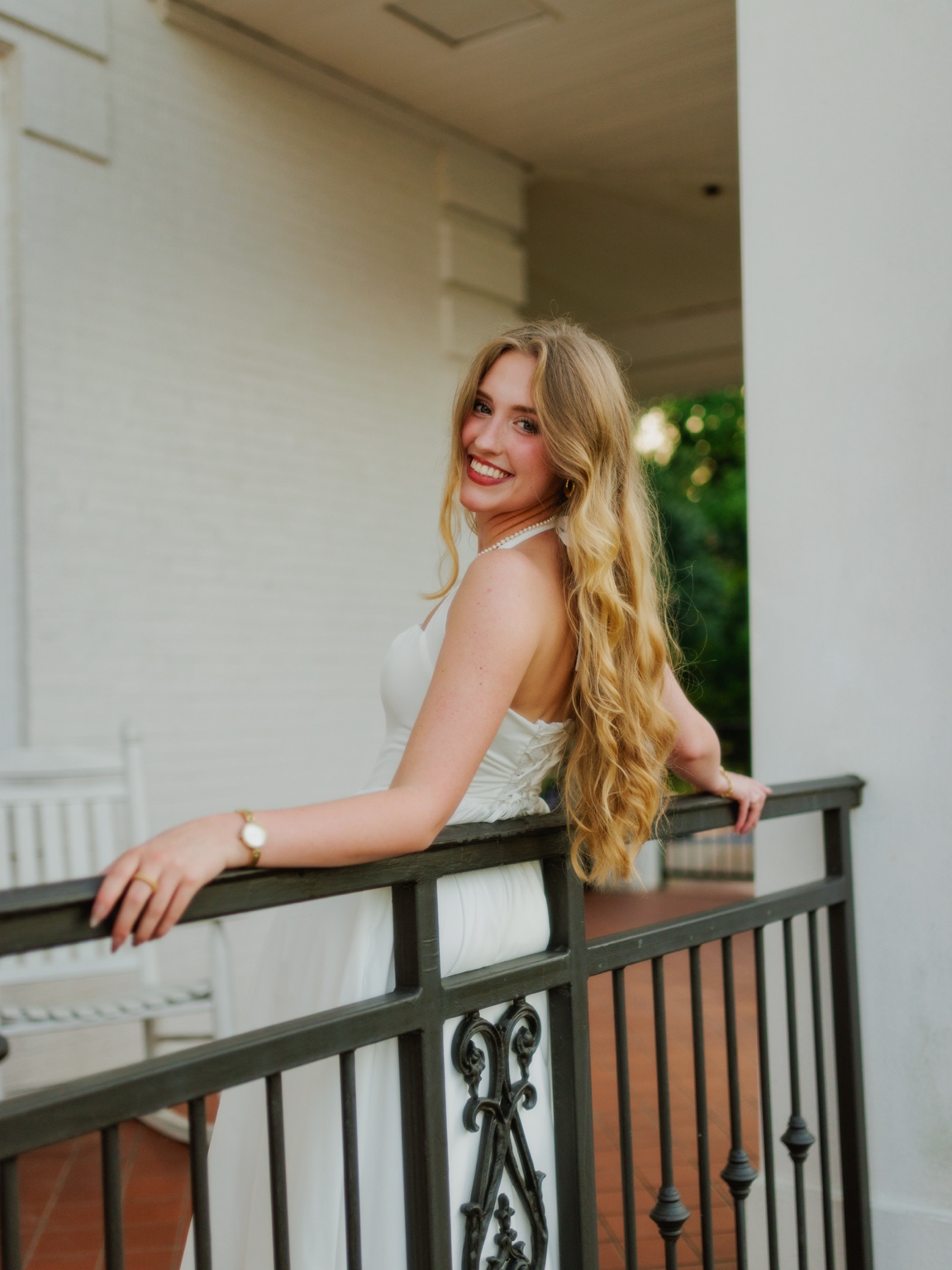 Graduate by a campus railing