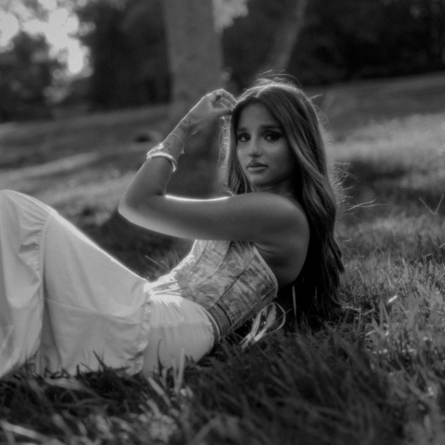 Black and white portrait reclining in grass