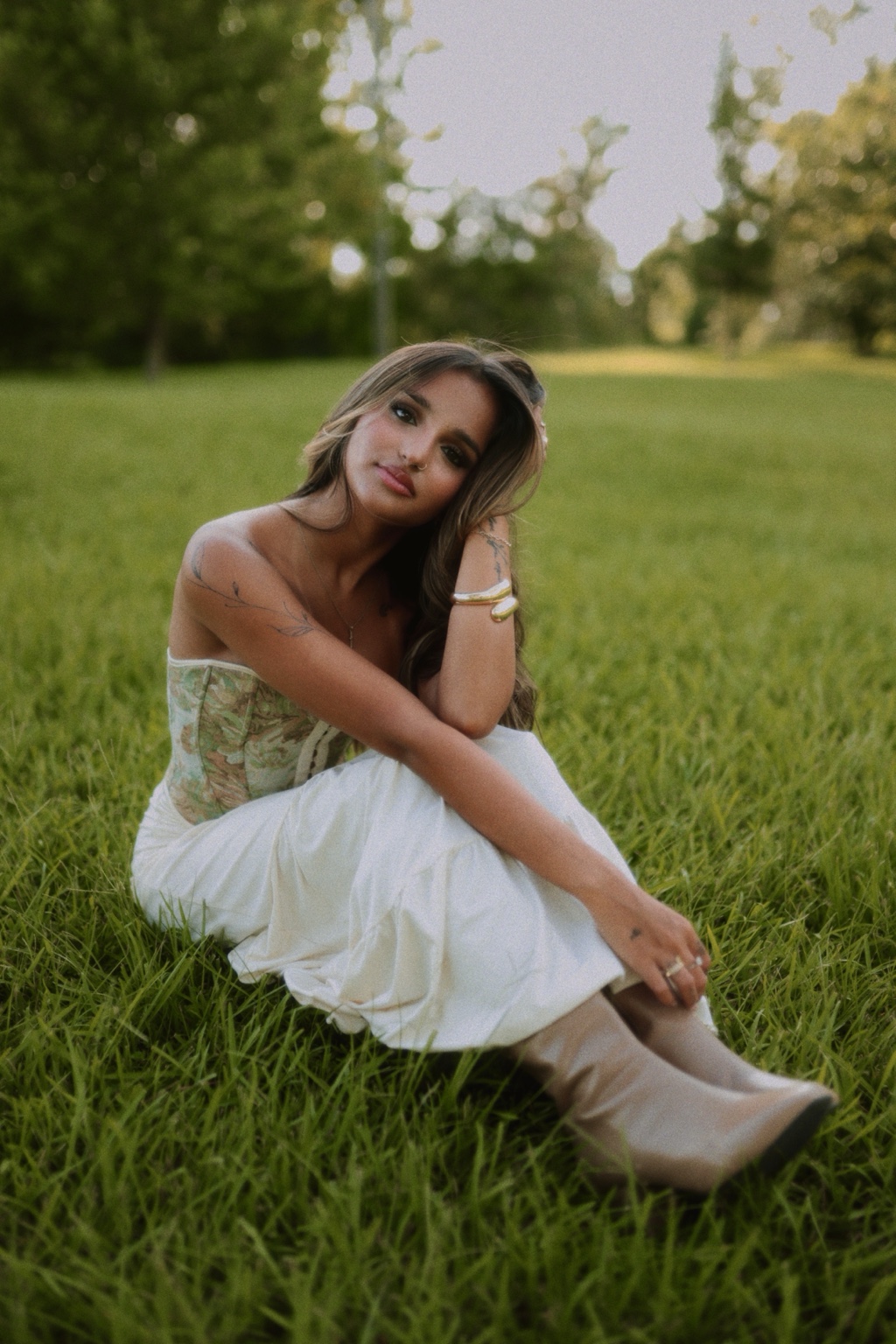 Portrait seated in a grassy field